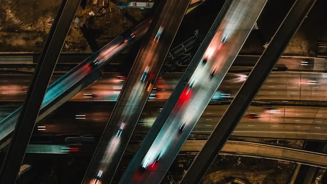 An aerial view of a freeway interchange at night
